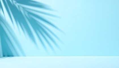 Soft blurred palm shadows fall across a pastel blue wall, forming a clean minimal backdrop ideal for bright seasonal product presentations.