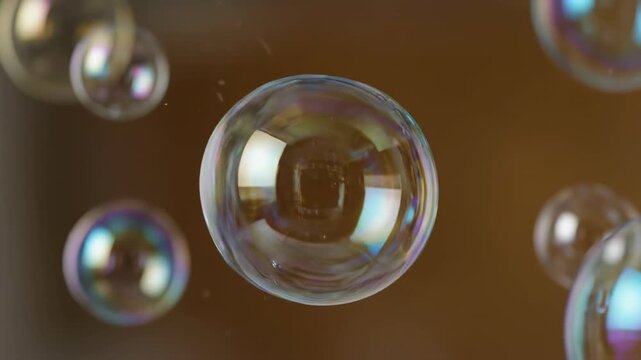 Shiny transparent soap bubbles and liquid glass spheres reflecting light as they float in the air against red and black backgrounds