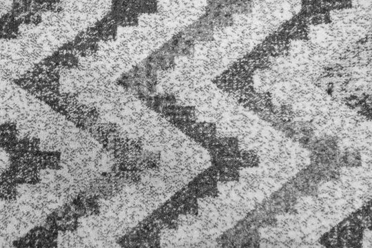 Textured black and white fabric with zigzag pattern captures attention in home decor setting for cozy atmospheres