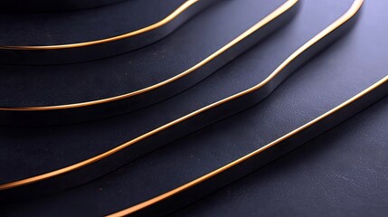 A close-up abstract view of layered dark surfaces with thin, shiny gold trim along the edges, creating a sense of depth and luxury.