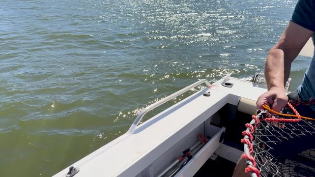 Lowering Crab Trap from Boat into Gold Coast Waterway