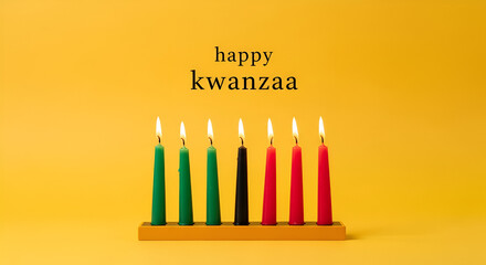 Colorful kinara candles lit for kwanzaa on yellow background with happy kwanzaa message, celebrating african heritage and unity