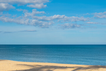 Obraz premium Nature of the ocean and blue sky Summer with sunshine, sandy beaches, clear blue waters sparkling against the blue sky. on an island with good ecology and environment Background for summer vacation