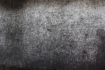 The wall is a rough white surface with black stains on it. Ideas for textured images, chalkboards, free space for text. and decorative patterns