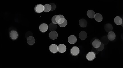 Low-key black-and-white bokeh with visible but fine grain, multiple small highlights