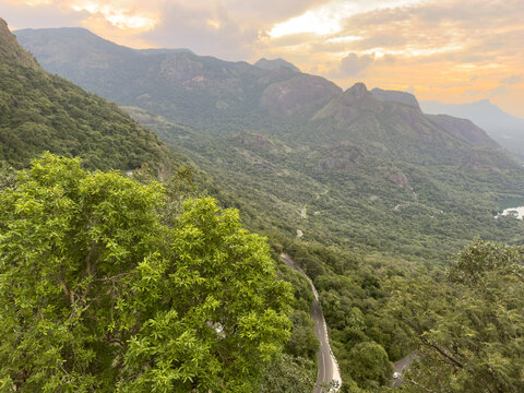 Scenic view from Loam's View Point showing lush green forested mountains and winding ghat road en route to Valparai from Aliyar in Coimbatore district, Tamil Nadu.