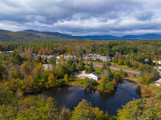 Fototapeta premium Moultonboro historic town center aerial view in fall with Red Hill at the background, Moultonboro, New Hampshire NH, USA. 
