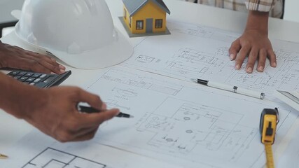 Teamwork: Architects collaborate on blueprints for sustainable building project - Powered by Adobe