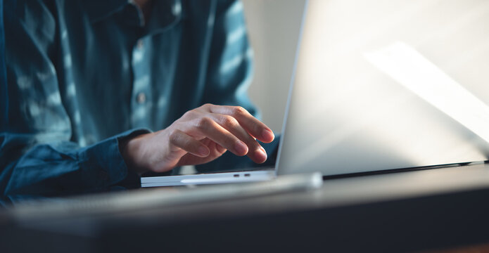 Close up, woman typing on laptop, online working with digital tablet on office table. Woman surfing the internet, searching the information on laptop computer, internet technology