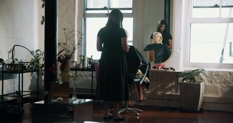 Women, hairdresser and discussion with mirror, grooming services and results with cosmetics at salon. People, client and hairstyle with talk, customer experience or beauty with transformation at shop