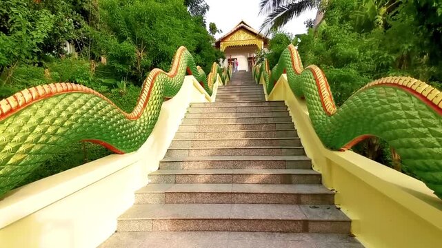 Suwankeereewong Temple green naga statue statues sculpture sculptures stairs Thailand.