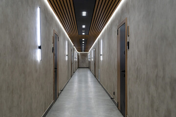Modern corridor with doors and linear LED lighting