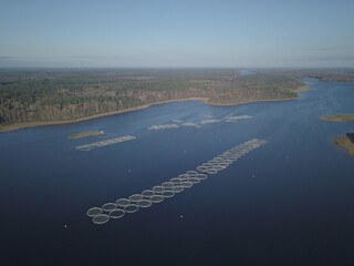 Aerial aquaculture fish farm cages on a lake reservoir