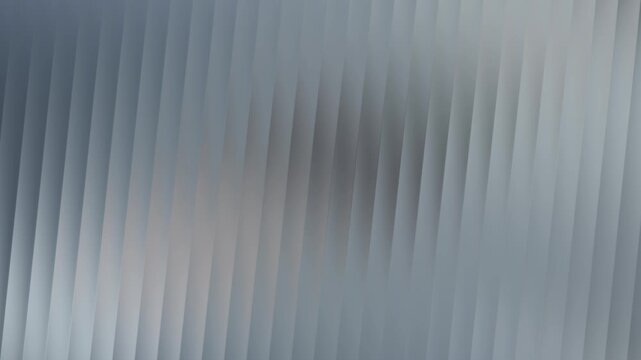 A mesmerizing display of vertical blinds, casting subtle shadows and creating a rhythmic pattern of light and dark, evoking a sense of calm and order