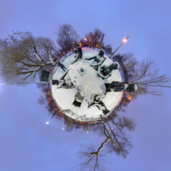 Tiny Planet: winter city park with sculptural group at dusk