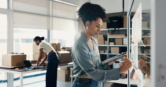 Shipping, woman and writing on glass wall with tablet, ecommerce ideas or analysis. Tech logistics and entrepreneur with sticky note for distribution strategy, startup planning and graphs in office