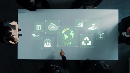 A diverse business team collaborates in a modern office, examining ESG concepts through icons projected on a table, focusing on sustainable practices and growth. Raster - Powered by Adobe