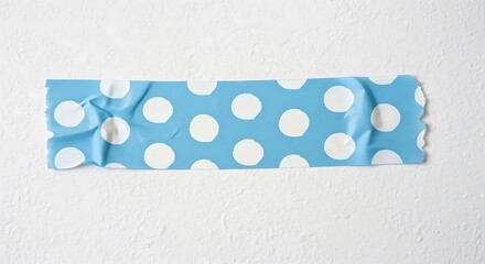 Blue gift wrap with white polka dots tied with a ribbon