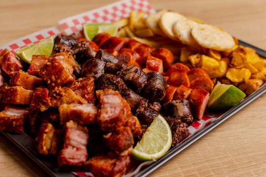 Colombian meat platter with sausages, chicharr&oacute;n and fries