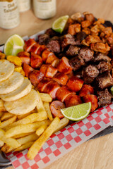 Colombian meat platter with sausages, chicharrón and fries