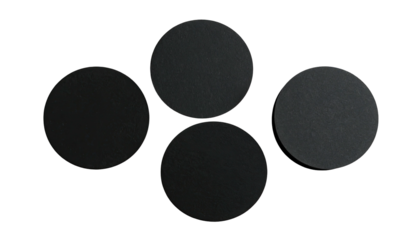 Four dark, textured circles on a black background