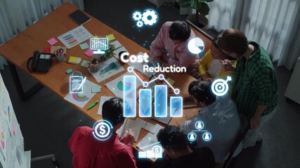A diverse business team engages in a productive meeting focused on strategies for cost reduction. Digital icons and visual data enhance collaborative efforts. Raster - Powered by Adobe