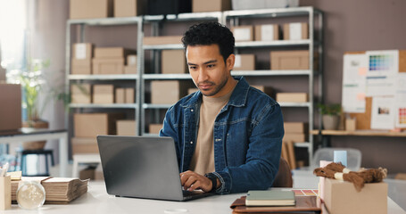 Man, typing and laptop for logistics of ecommerce for inventory update, online order and delivery....