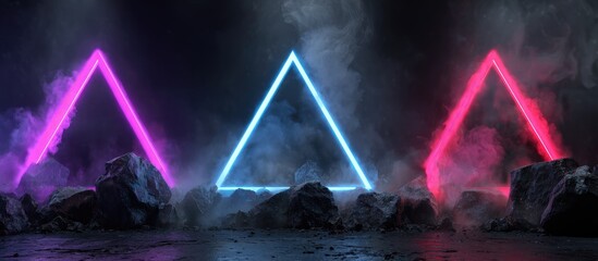 Three luminous triangular neon lights in pink, blue, and red, stand amidst smoky fog and dark rocks on a reflective surface