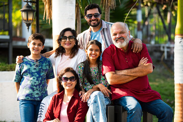 Indian family enjoying outdoor bonding time on steps during weekend relaxation
