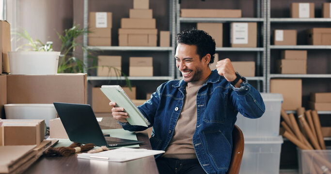 Man, cheering and tablet with boxes for ecommerce with good news, online sales and order success. Excited, male person or fist pump with digital, shipping deal and celebration of logistics promotion