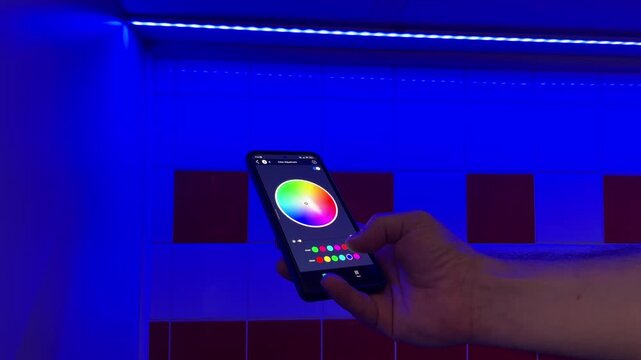 Using smart home multicolor diode led line lght in an aluminum profile glows a blue RGB color by phone app	