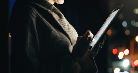 Tablet, hands and businesswoman in city at night with communication for finance review. Digital technology, bokeh and female financial manager with email for investment proposal in urban town.