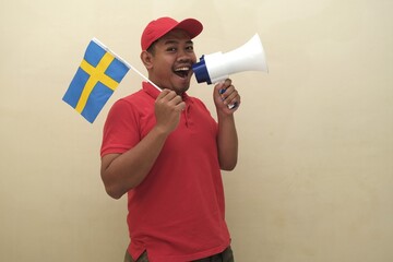 Southeast Asian man holding Swedish flag and megaphone, promoting visa, scholarship, or study...