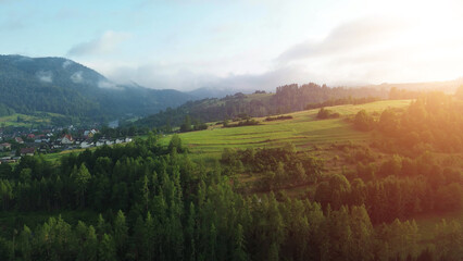 Golden dawn light above foggy mountain valley
