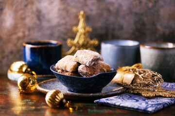 Traditional christmas cookies in a bowl on a rustic wooden background. Soft focus.	