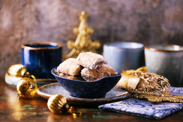 Traditional christmas cookies with gingerbread in a bowl on a rustic wooden background. Soft focus.	