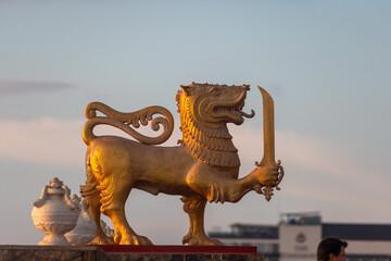 Golden Sinhalese lion statue at sunset in Colombo, Sri Lanka
