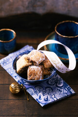 Traditional christmas cookies in a bowl on a rustic wooden background. Soft focus.	