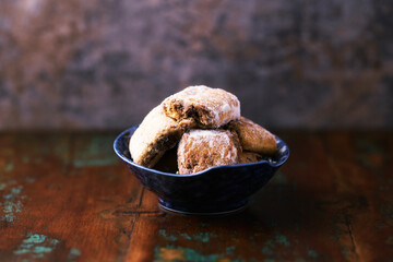 Traditional christmas cookies in a bowl on a rustic wooden background. Soft focus.	