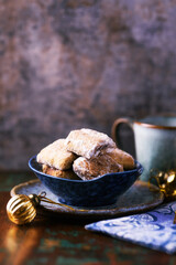 Traditional christmas cookies in a bowl on a rustic wooden background. Soft focus.	