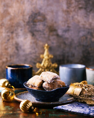 Traditional christmas cookies in a bowl on a rustic wooden background. Soft focus.	