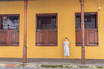 Young woman standing by a colonial-era building in the Dutch Hospital precinct, Colombo, Sri Lanka