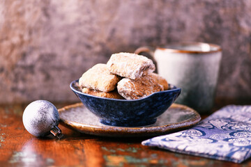 Traditional christmas cookies in a bowl on a rustic wooden background. Soft focus.	