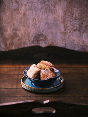 Traditional christmas cookies in a bowl on a rustic wooden background. Soft focus.	