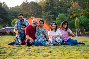Indian family smiling together while camping and enjoying relaxed outdoor moments