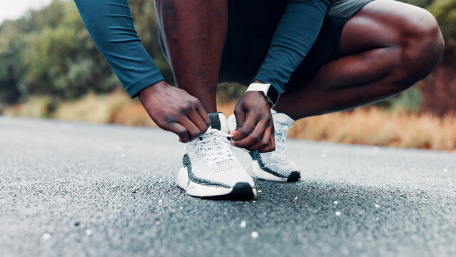 Hands, person and tie shoes for fitness routine, endurance training and running preparation. Athlete, runner and tying laces for exercise safety, getting ready and sports workout for wellness outdoor