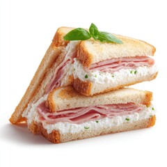 Two toasted ham and cream cheese sandwiches, stacked, with basil garnish