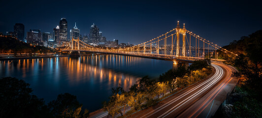 City Lights at Night: A captivating cityscape glistens with illuminated bridges and buildings, mirroring gracefully in the tranquil water, with streaks of light painting the road.