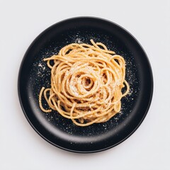 A plate of cooked spaghetti, nestled in a circular, dark-grey, black plate, topped with a sprinkle of cheese