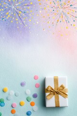 A beautifully wrapped gift box sits against a colorful backdrop with confetti and colorful splashes, perfect for celebrations or special occasions.